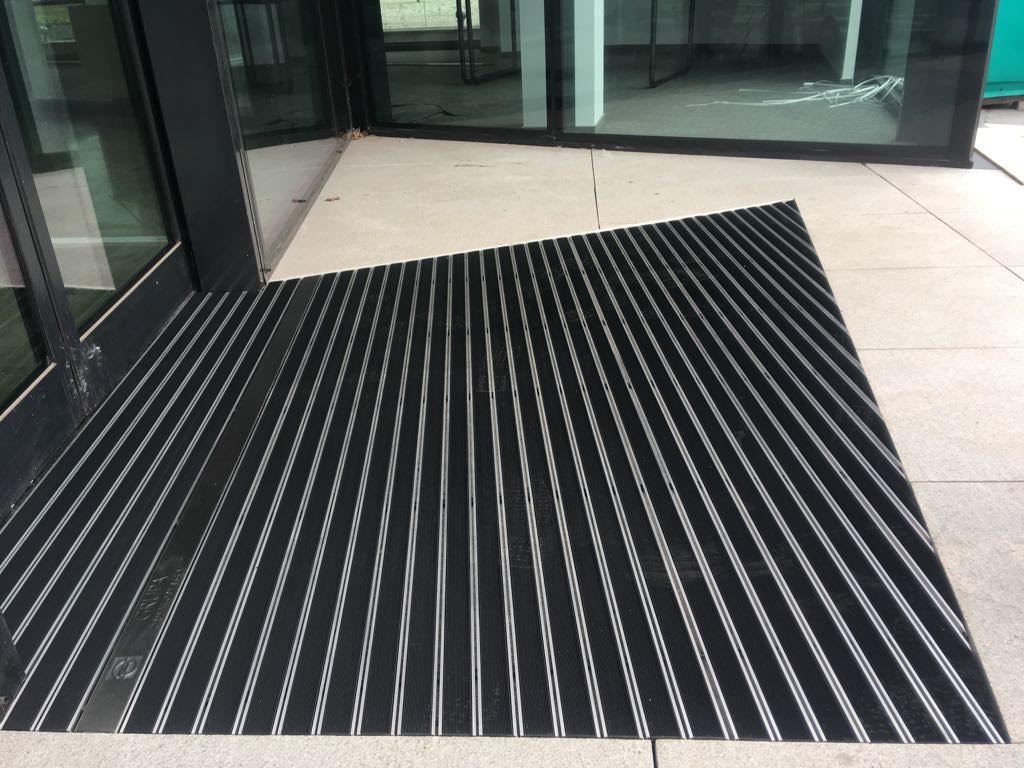 Inside the building, custom-made entrance mats are perfectly tailored to fit the space.