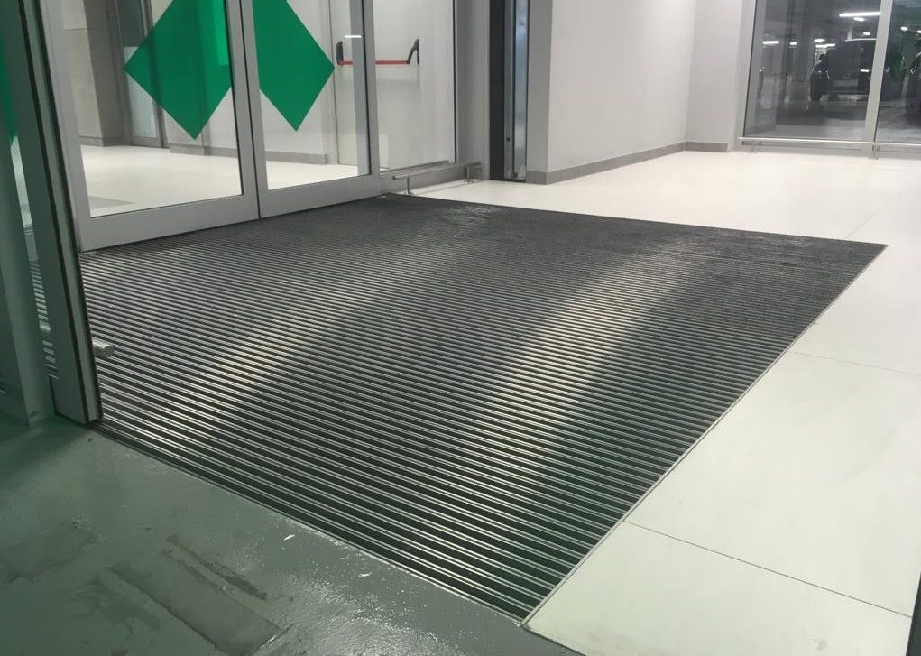 The interior of the building features entrance mats that effectively trap dirt and moisture from shoe soles.