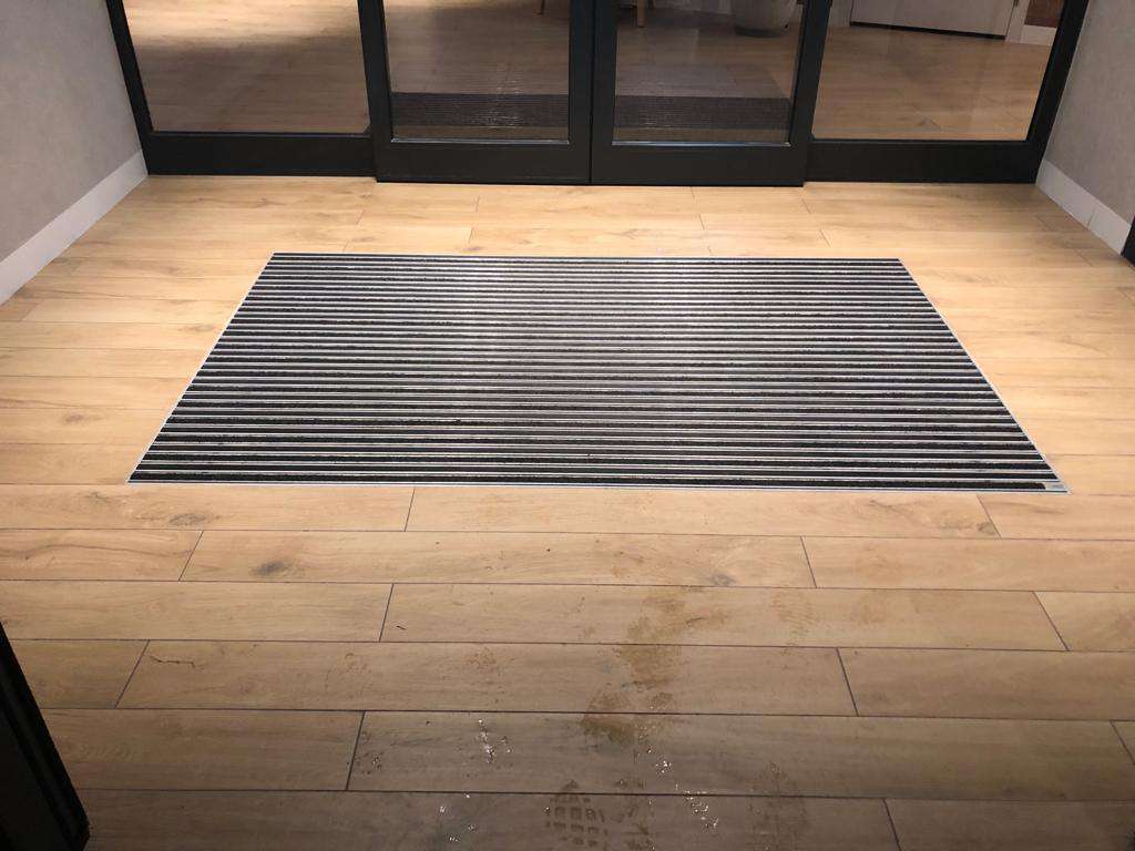 Embedded clean-run mat. The building entrance is secured.
